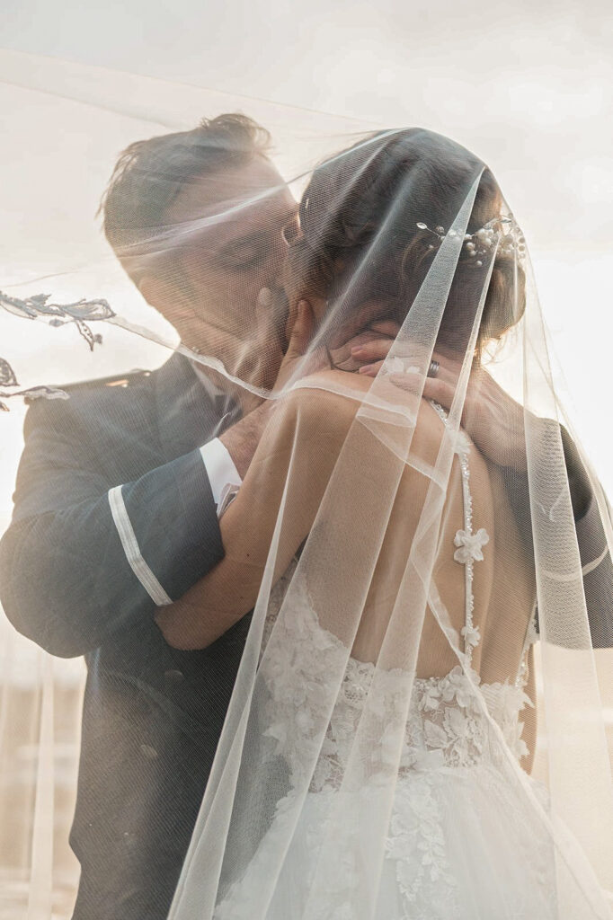 Portrait of couple kissing under the veil