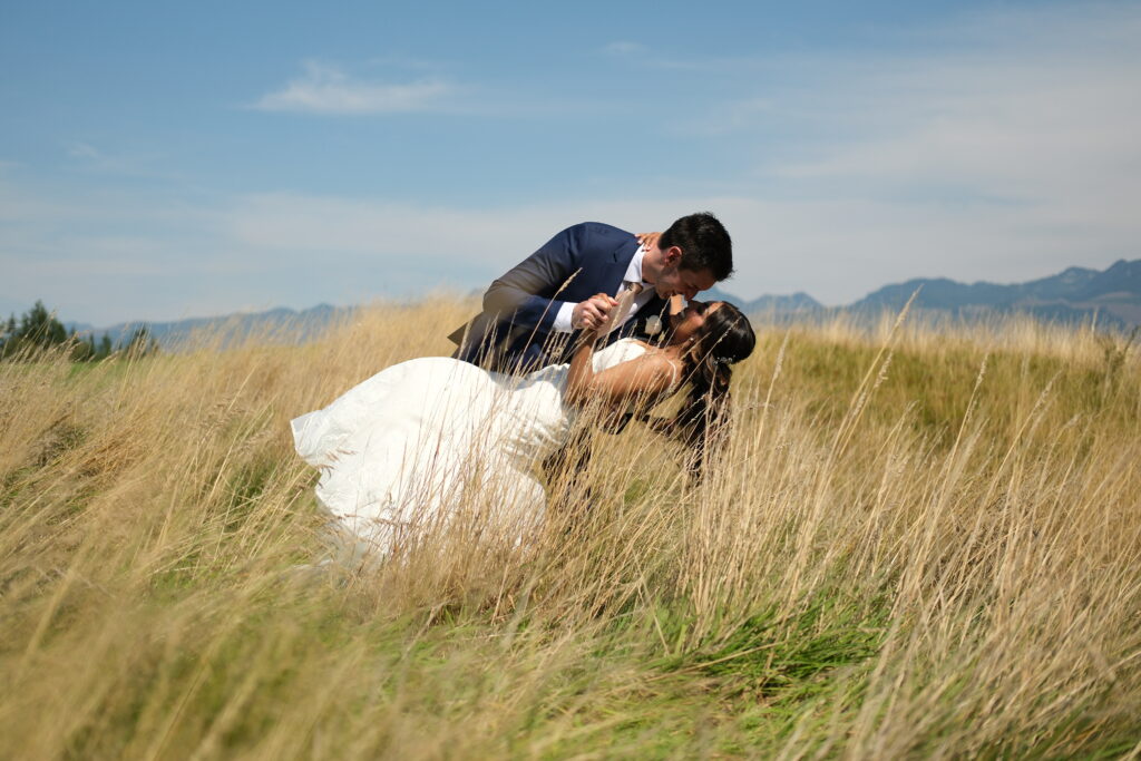 Wedding portrait of kiss in the tall grass
